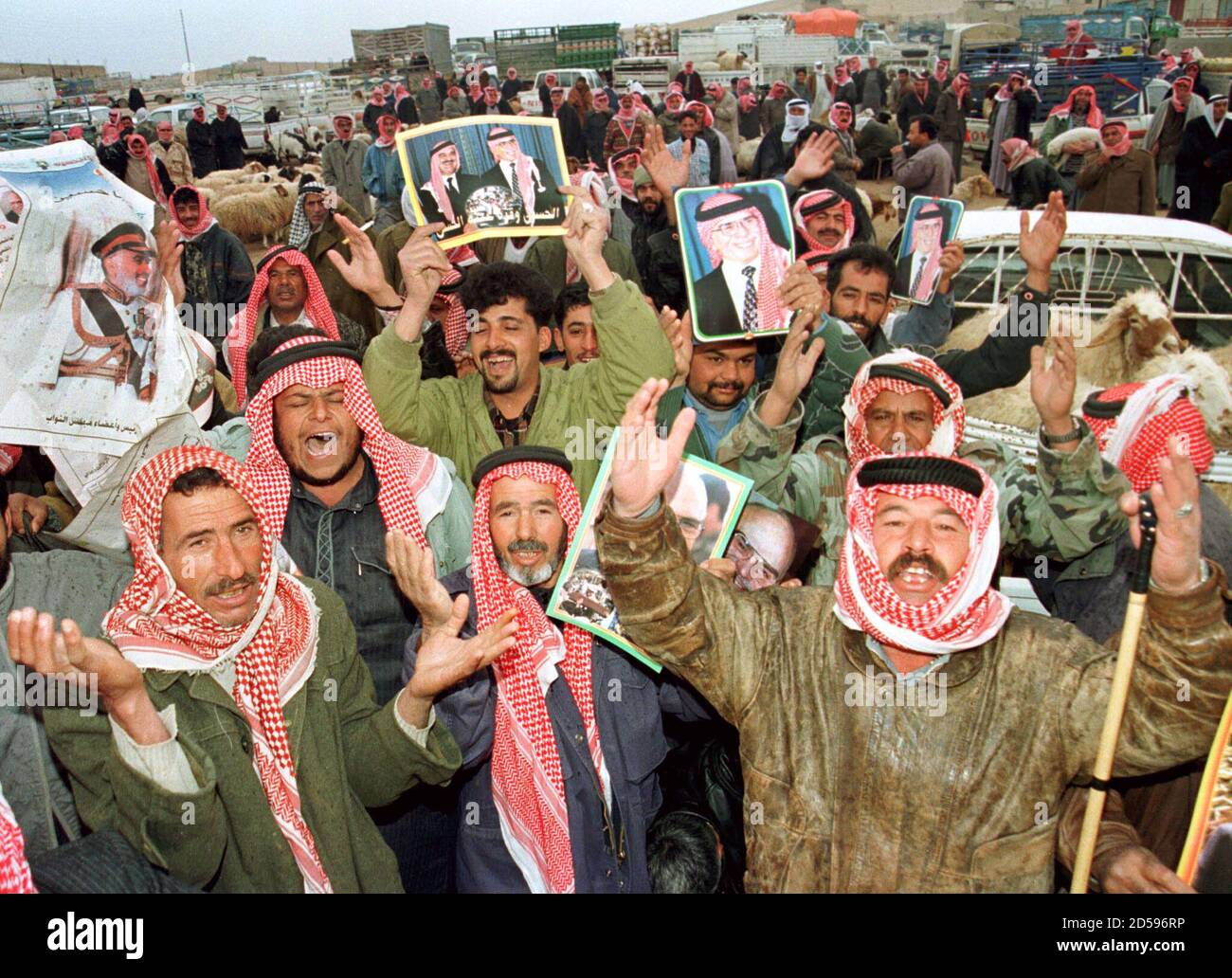 Jordanian Bedouins lift up pictures of King Hussein as they cheer and pray  for their king in the town of Sahab near Amman February 7. Jordan moved  into a new era after [