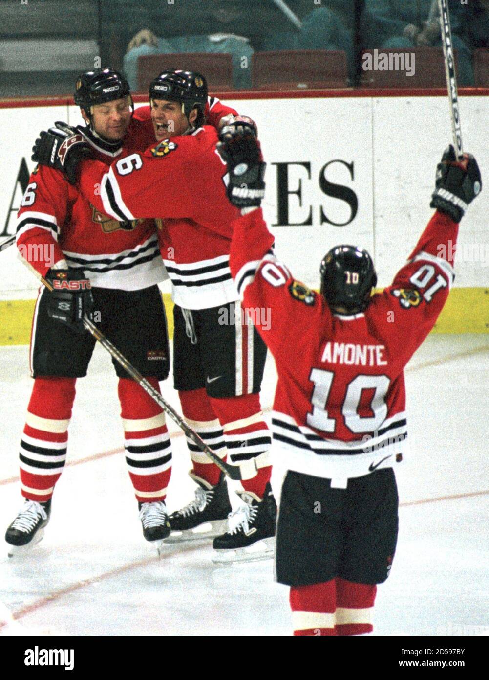 Chicago Blackhawks center Alexei Zhamnov (L) embraces Ed Olczyk as their  teammate Tony Amonte (10) raises his arms as they celebrate Olczyk's first  period goal against the Colorado Avalanche in Denver, March