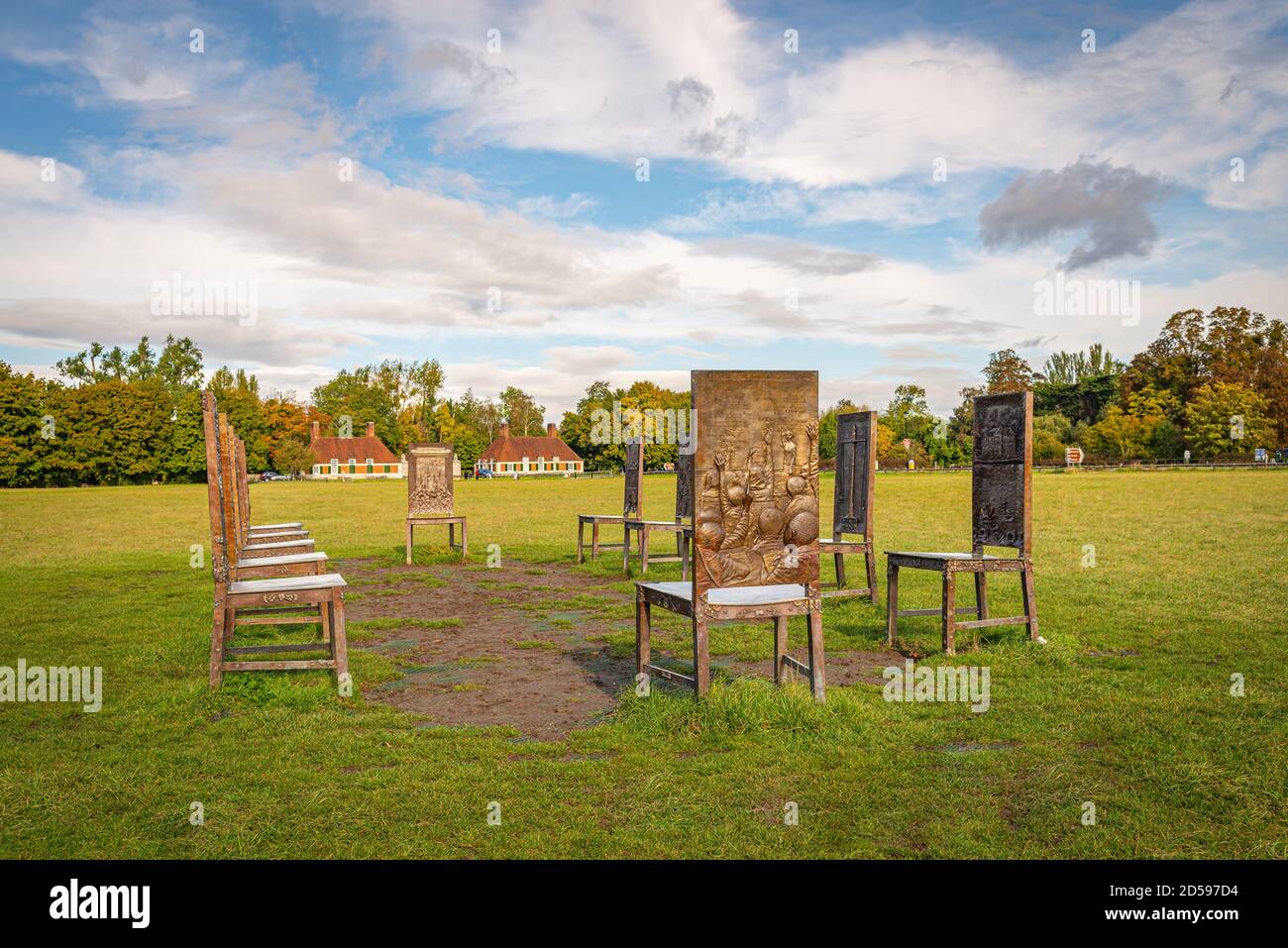 Bronze chairs 'The Jurors' A sculpture by Hew Locke on a sunny day with light cloud to mark the 800th anniversary of Magna Carta. Runnymede, Windsor Stock Photo