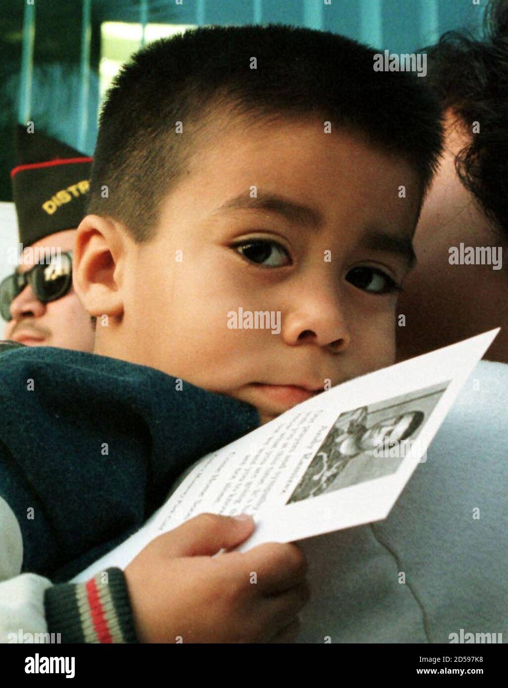 The nephew of captured U.S. Army Staff Sgt Andrew Ramirez, Austin Vela, 4,  holds a photo of his uncle during a community rally in support of the  Ramirez family in East Los