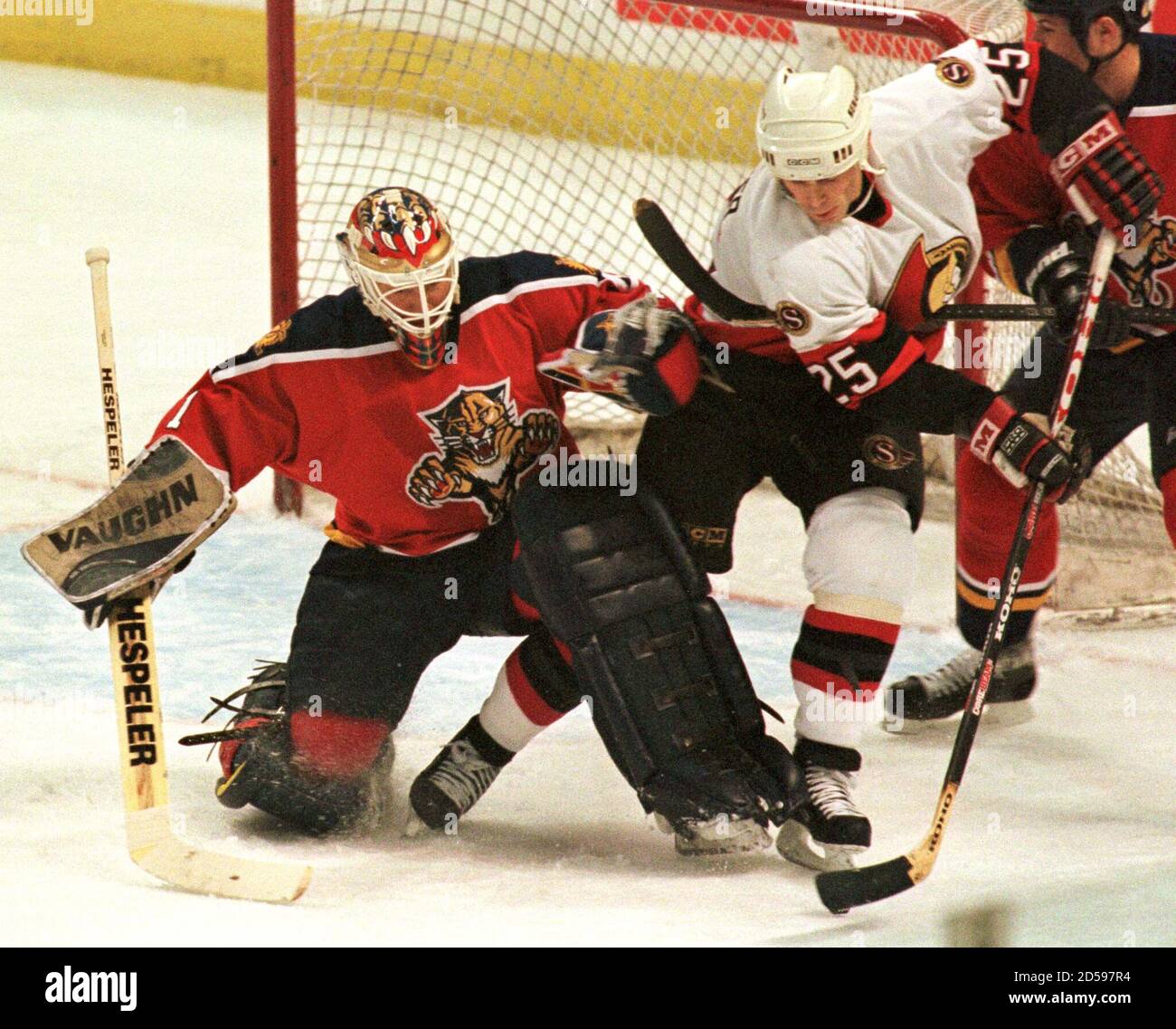 Ottawa Senators Bruce Gardiner (R) collides with Florida Panthers goalie  Kirk McLean (L) as he is hooked from behind during first period action at  the Corel Center in Kanata, Ontario, April 12.