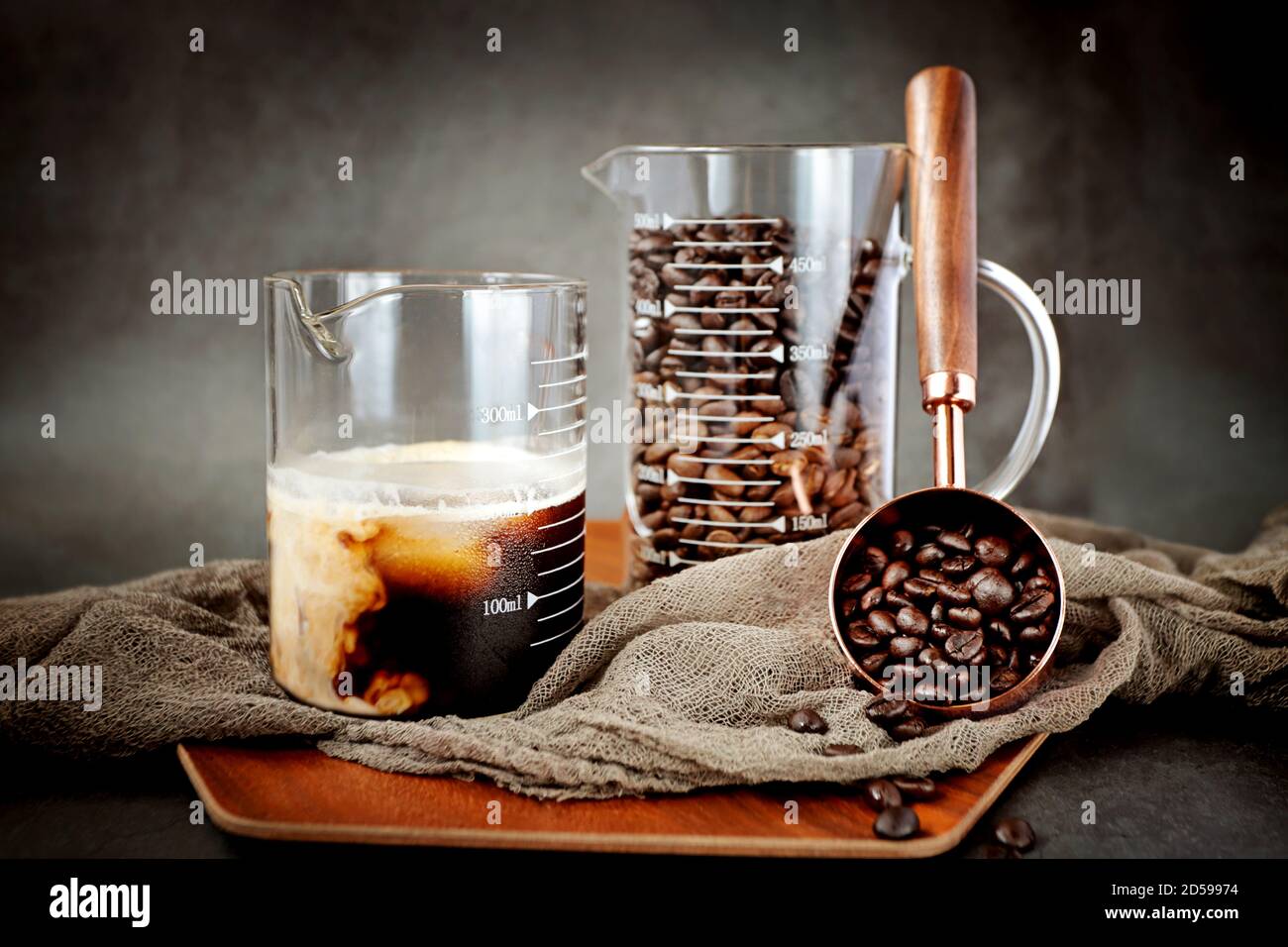 Roasted coffee beans and coffee in a beaker Stock Photo Alamy