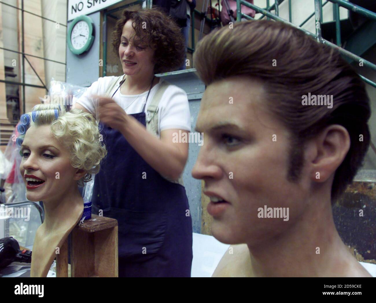 Madame Tussaud's manager of hair and wax Gill Griffith prepares the hair of  the wax bust of American film actress Marilyn Monroe, after finishing  American singer and actor Elvis Presley's bust, in