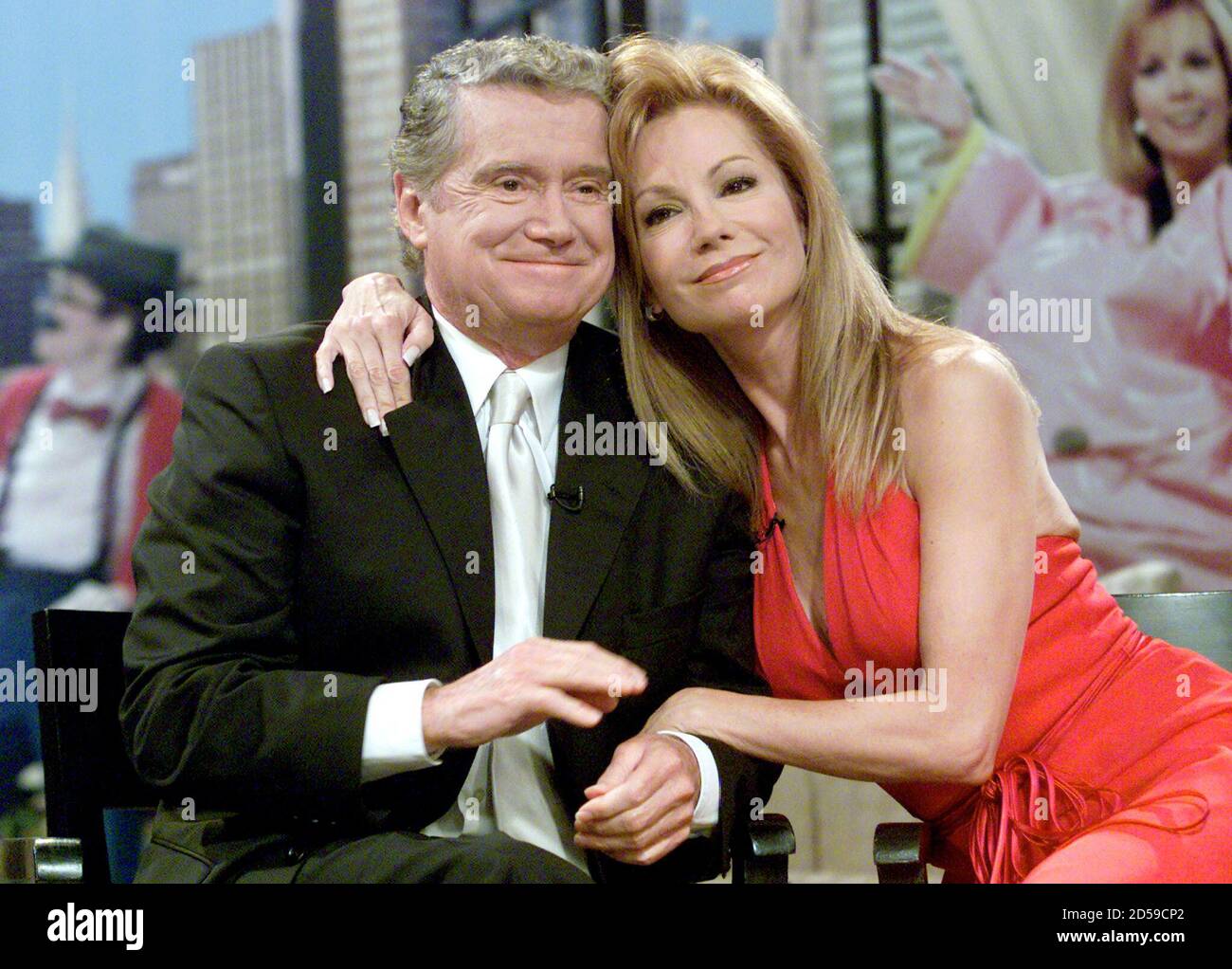 Talk show host Kathie Lee Gifford (R) hugs her co-host Regis Philbin during  Gifford's final appearance on their popular morning show 