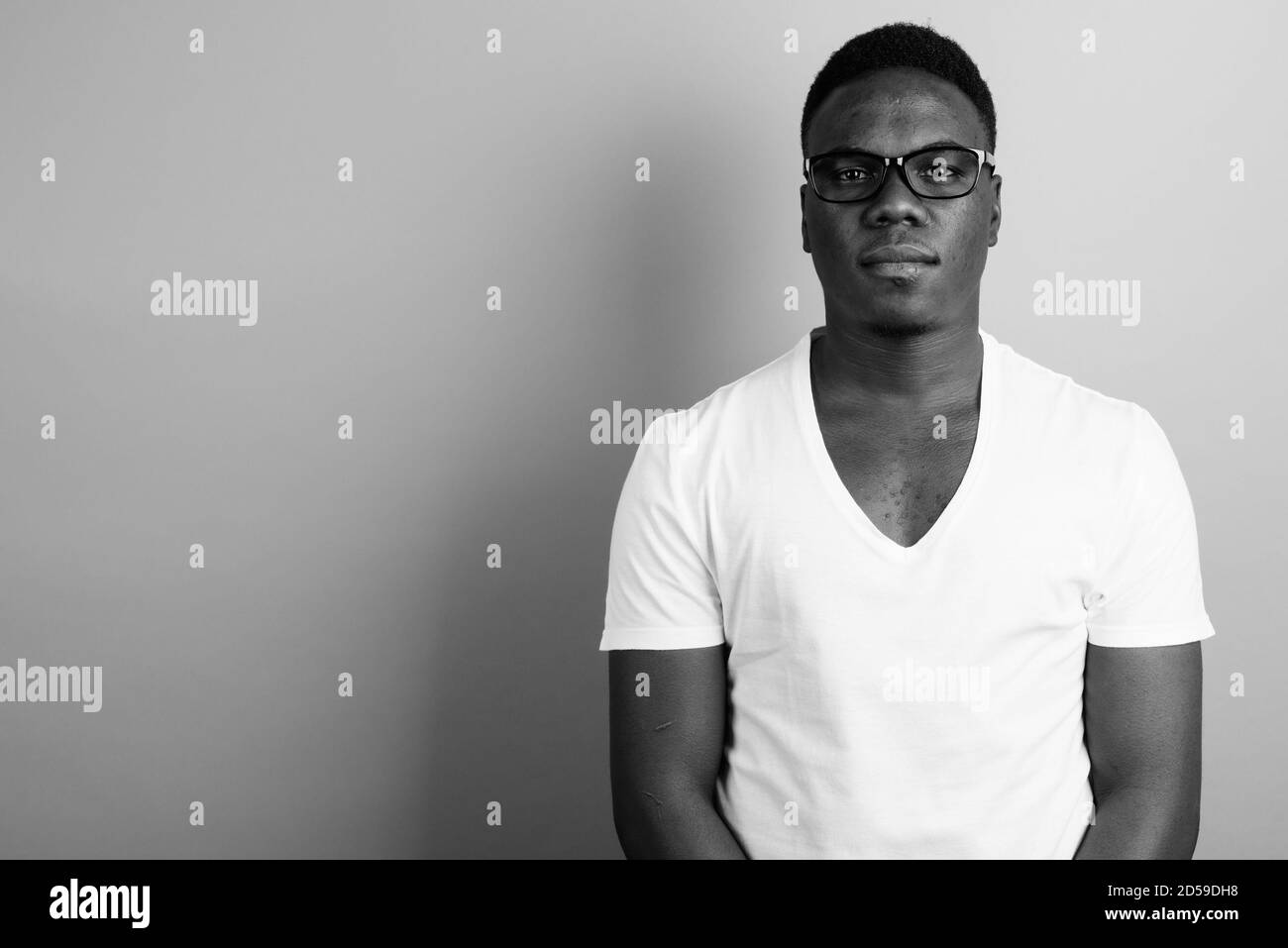 Portrait of young African man against white background Stock Photo - Alamy