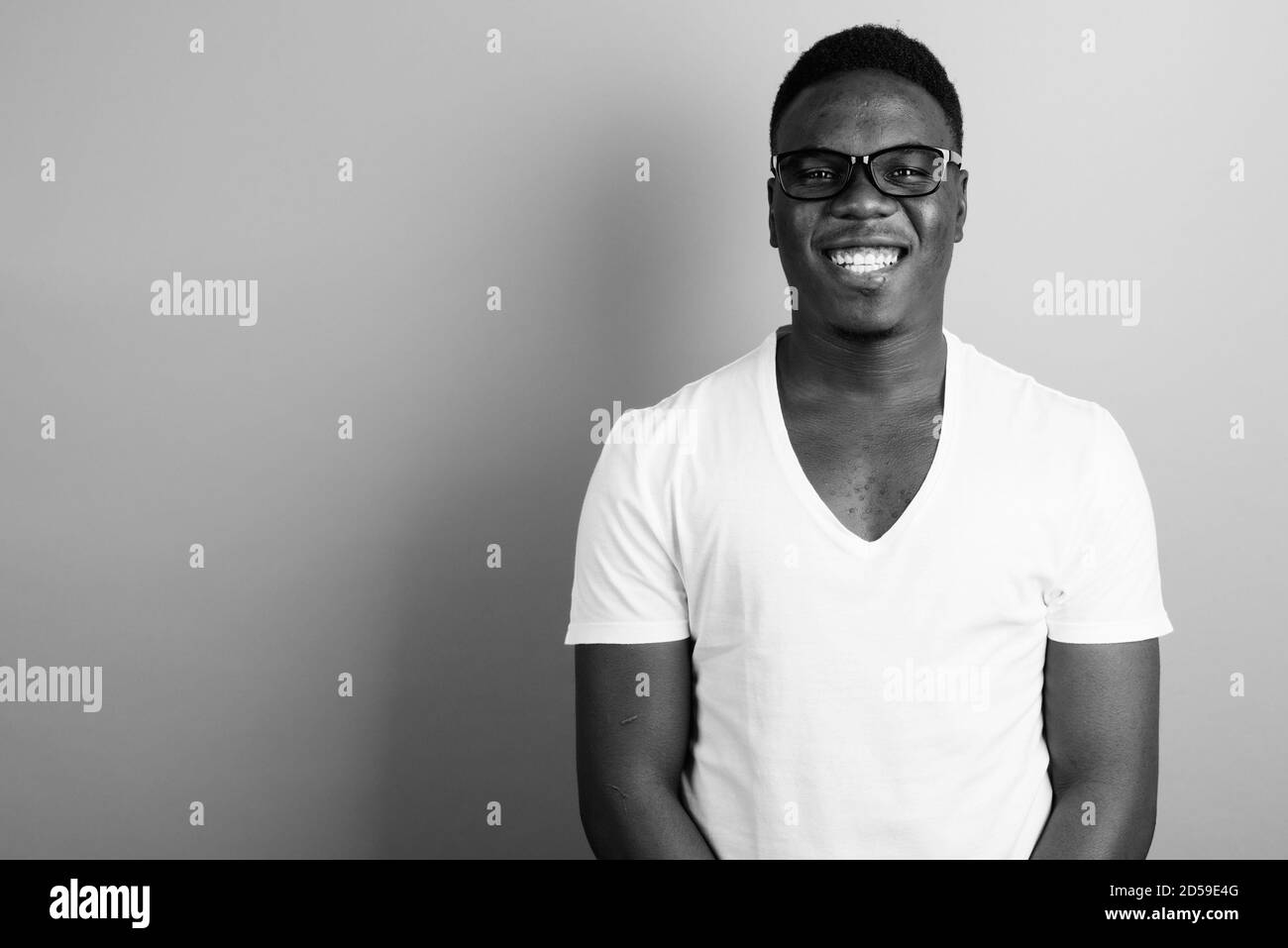 Portrait of happy young African man against white background Stock ...