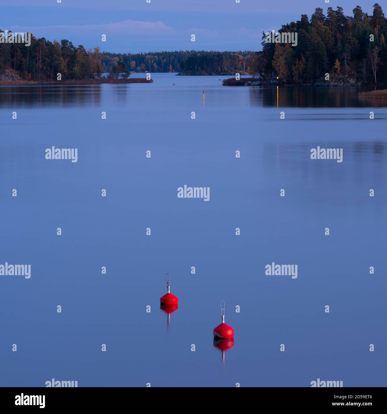 Helsinki/Finland - OCTOBER 11, 2020: Two red buoys floating in calm sea on a beautiful autumn evening. Stock Photo