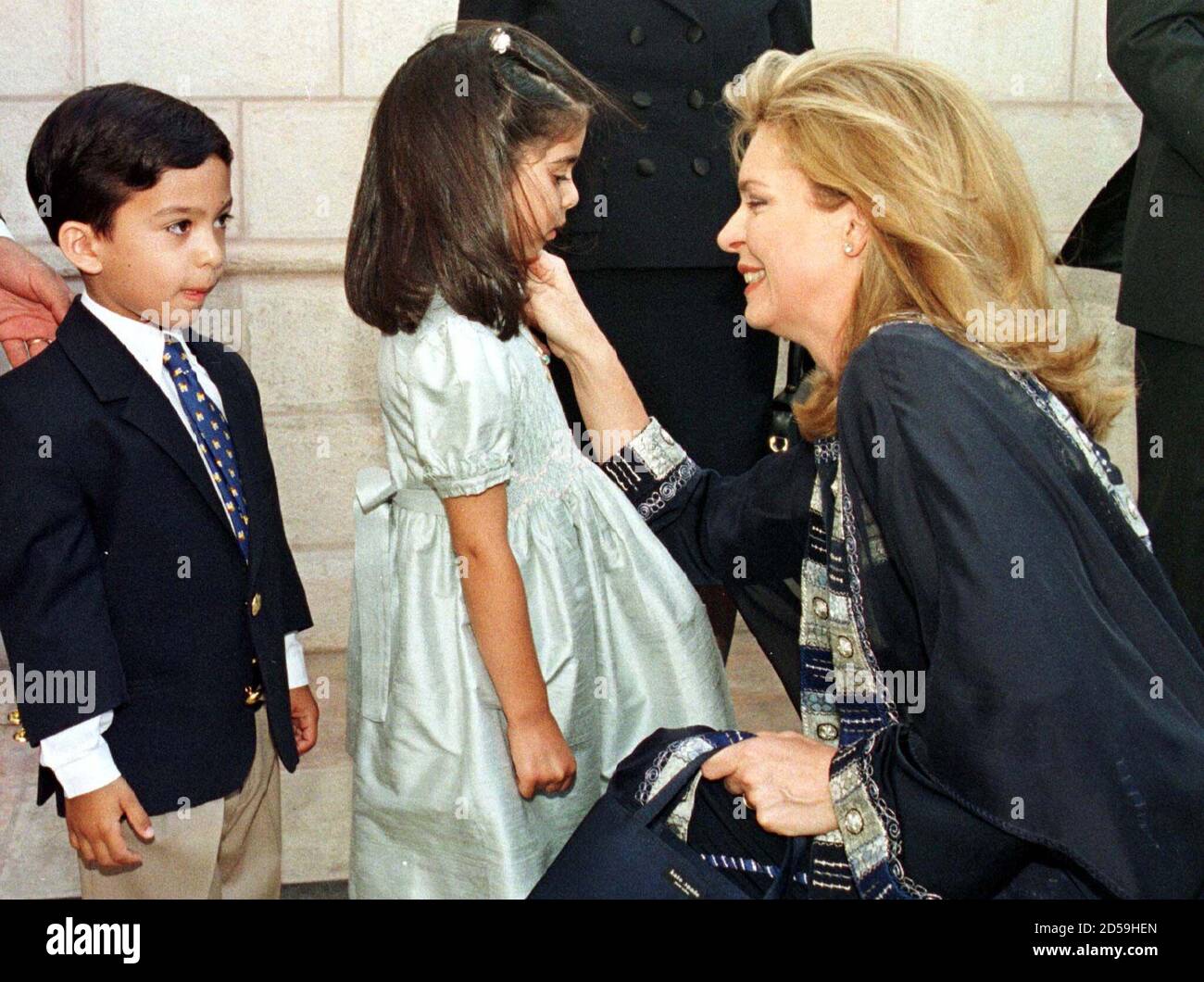 Queen Noor widow of the late Jordan's King Hussein reaches out to Zein  al-Sharaf and Tarek, nephew of Prince Hassan, at the opening ceremony of  the 19th Arab Children's Congress in Amman