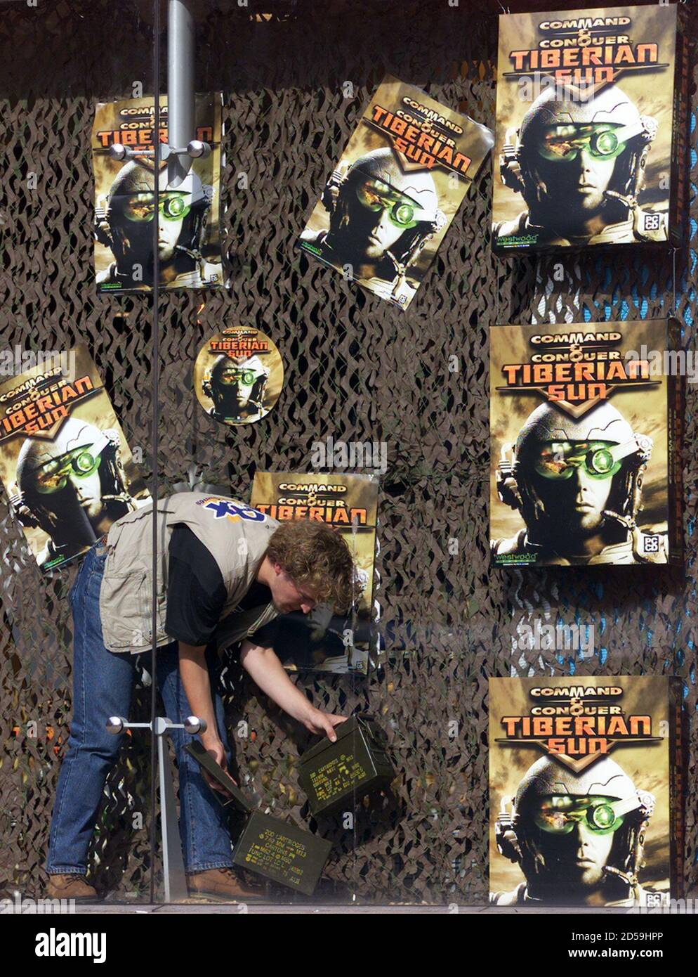A worker in a computer games store puts up a display advertising the  computer game "Tiberian Sun" by Westwood studios, Rotterdam August 24.  Tiberian Sun is the next instalment in the Command