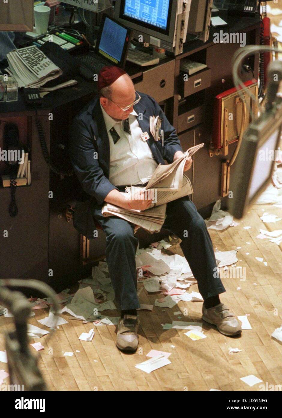 A Trader Sits Reading A Newspaper On The Floor Of The New York Stock Exchange Shortly After The Closing Bell In New York April 6 The Dow Jones Industrial Average Closed Above