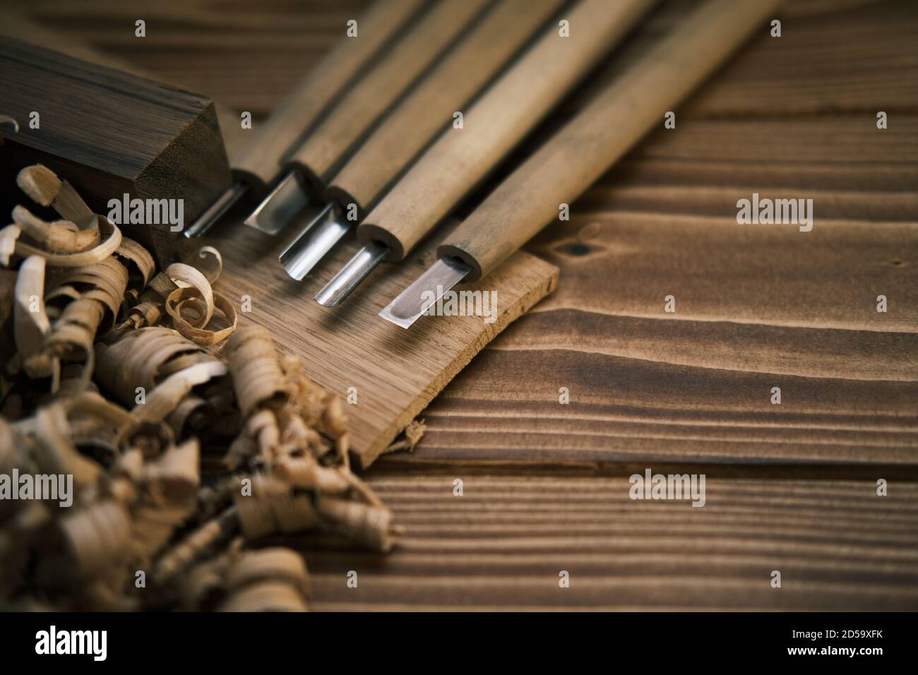 Close up view of a set of wood chisels for carving wood, sculpture tools on wooden background Stock Photo