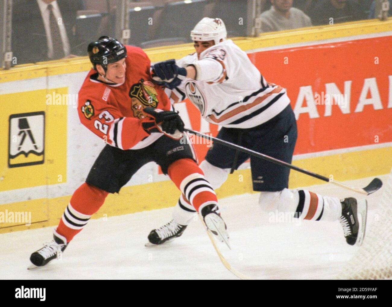 Chicago Blackhawks' Jean-Yves Leroux (23) gets roughed up along the boards by Edmonton Oilers' Sean Brown during first period action at the Skyreach Center in Edmonton Februry 2.  PB/SV Stock Photo