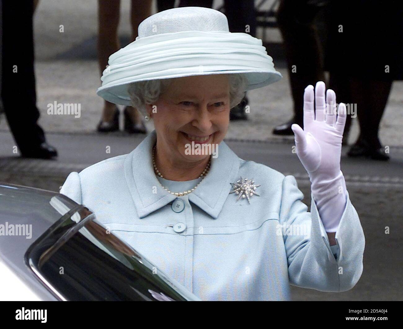 British Queen Elizabeth II waves to well wishers as she leaves the new British embassy after an opening ceremony in Berlin July 18. [The new embassy designed by British architect Michael Wilford is based on the same site as the old building which was destroyed by Allied bombers in World War Two. ] Stock Photo