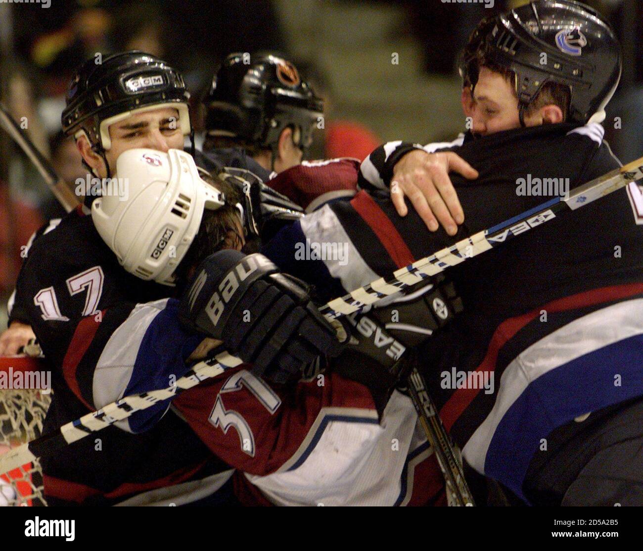 Colorado Avalanche's Chris Drury (C) is roughed up by in front of the net by Vancouver Canucks Bill Muckalt (L) and Bryan McCabe during first period NHL hockey at General Motors Place in Vancouver, December 29.  MB/RC/WS Stock Photo