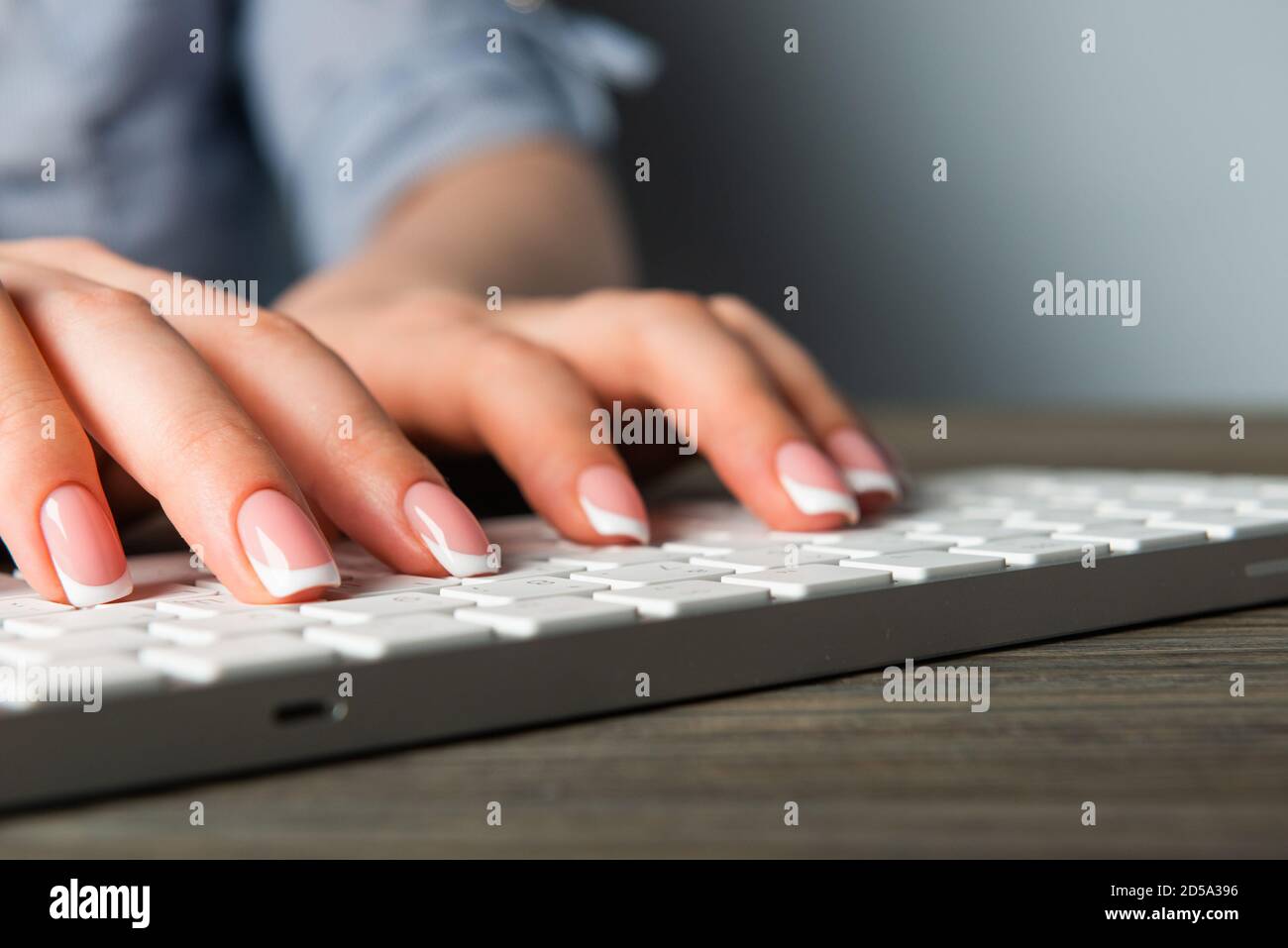 Female office worker typing on the keyboard Stock Photo