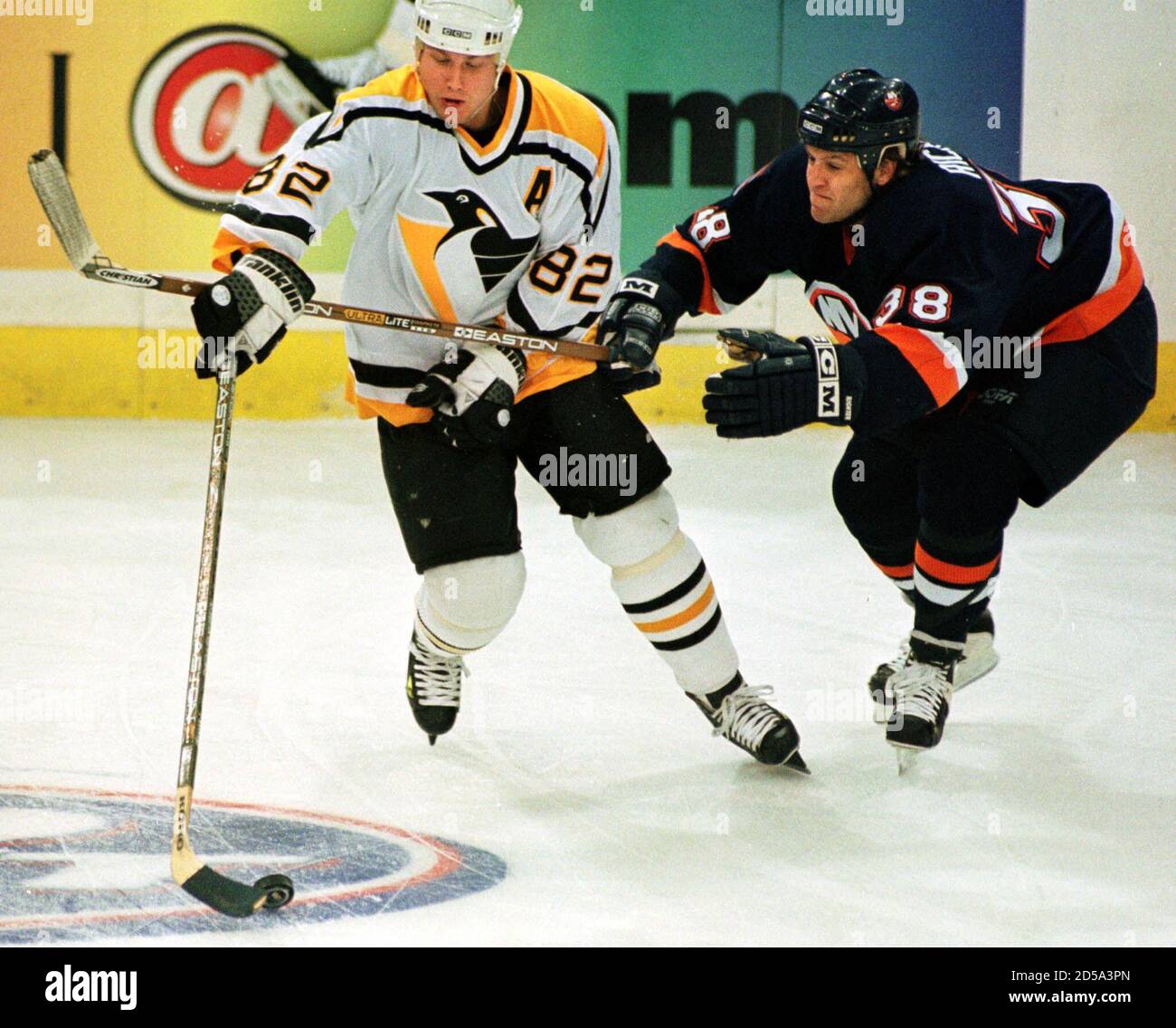 New York Islanders' Barry Richter (R) tries unsuccsessfully to reach for  the puck past Pittsburgh Penguins' Martin Straka (L) during the first  period in Pittsburgh on April 17. JC/GB Stock Photo -