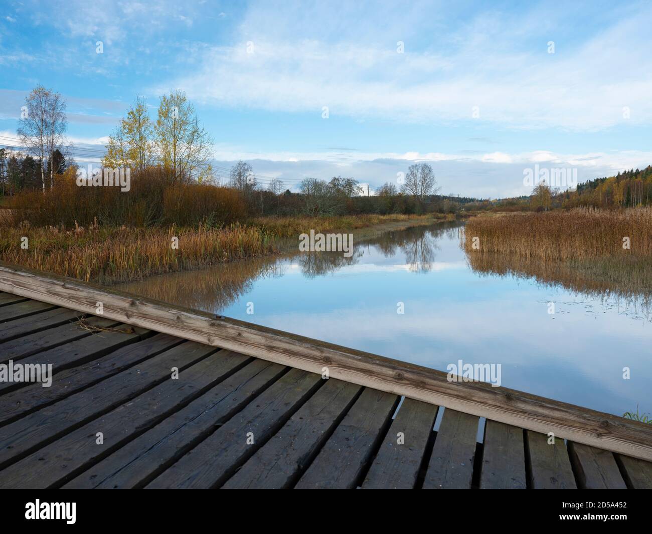 Sipoo/Finland - OCTOBER 12, 2020: A beautiful rural scene casting reflections on the calm river surface. Stock Photo