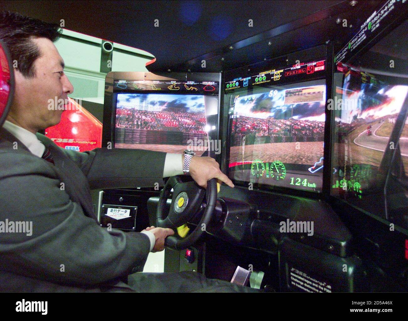 A Japanese man tries out the new Ferrari F355 Challenge racing car  simulator developed by Japanese game maker Sega Enterprises Ltd in Tokyo  May 19. The simulator offers five of the world's