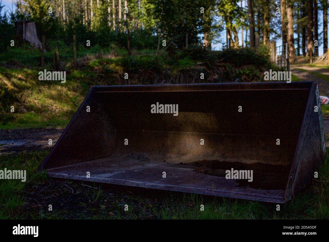 Tractor bucket in a woodland Stock Photo Alamy