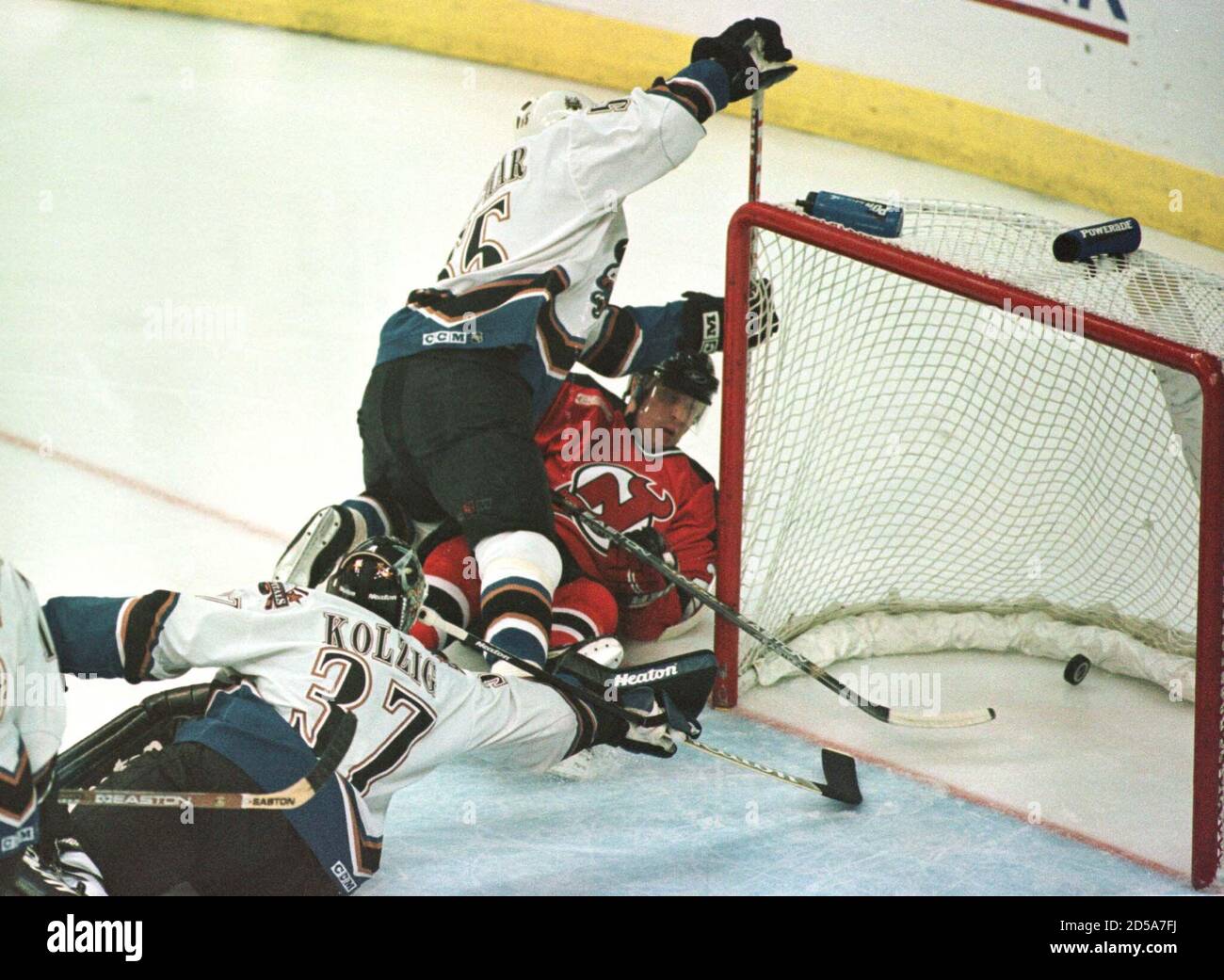 New Jersey Devils' Deron Quint (R) is 