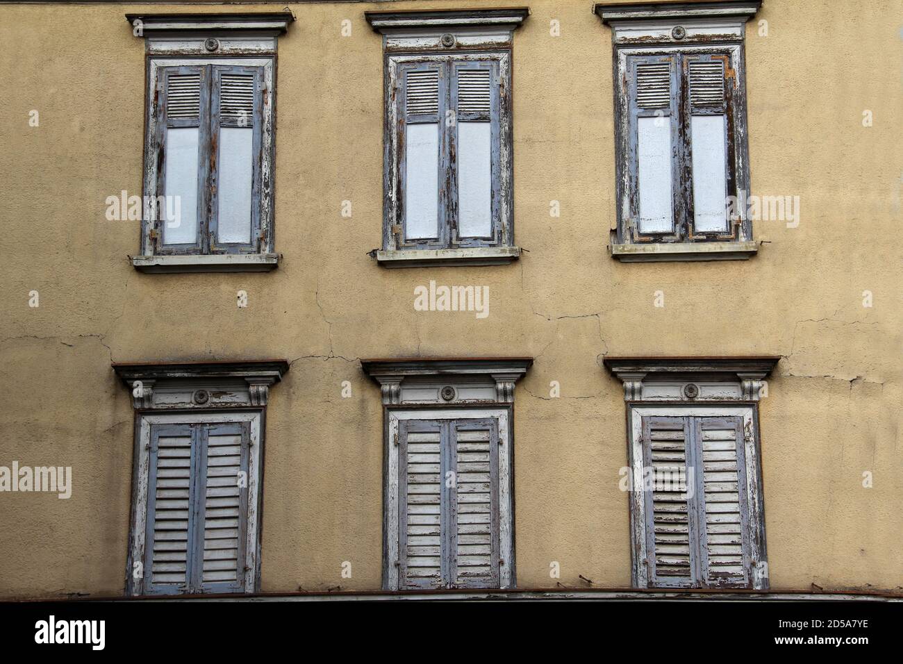 Low angle shot of closed windows on an old building Stock Photo - Alamy