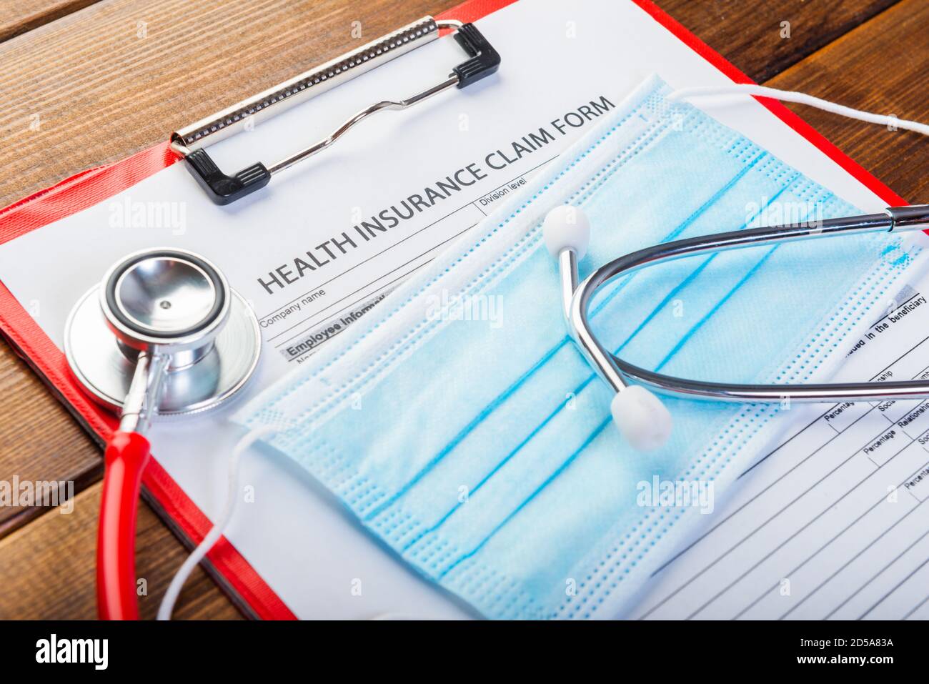 Health insurance claim form with stethoscope and surgical mask Stock Photo