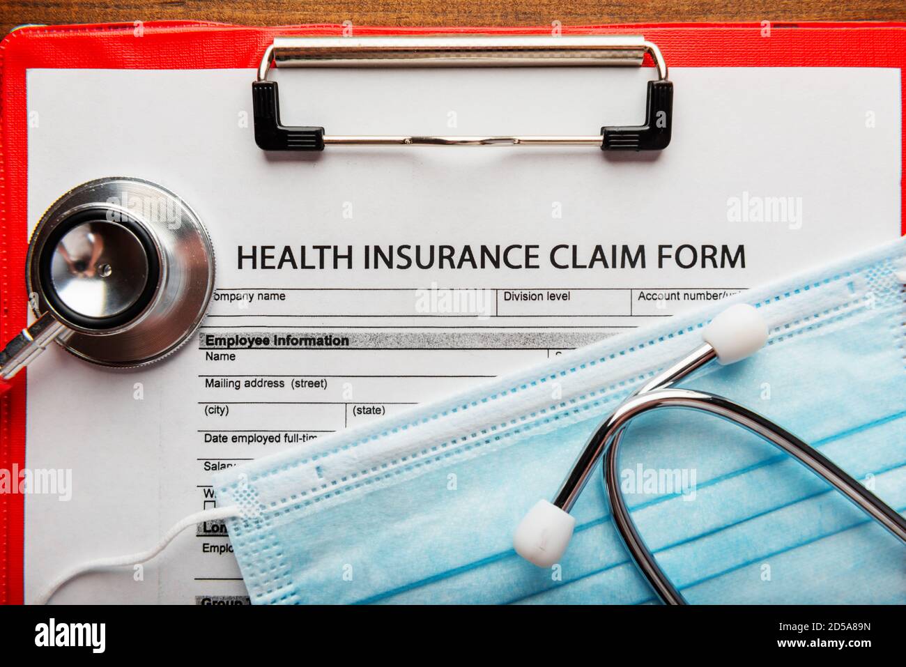 Health insurance claim form with stethoscope and surgical mask, top view Stock Photo