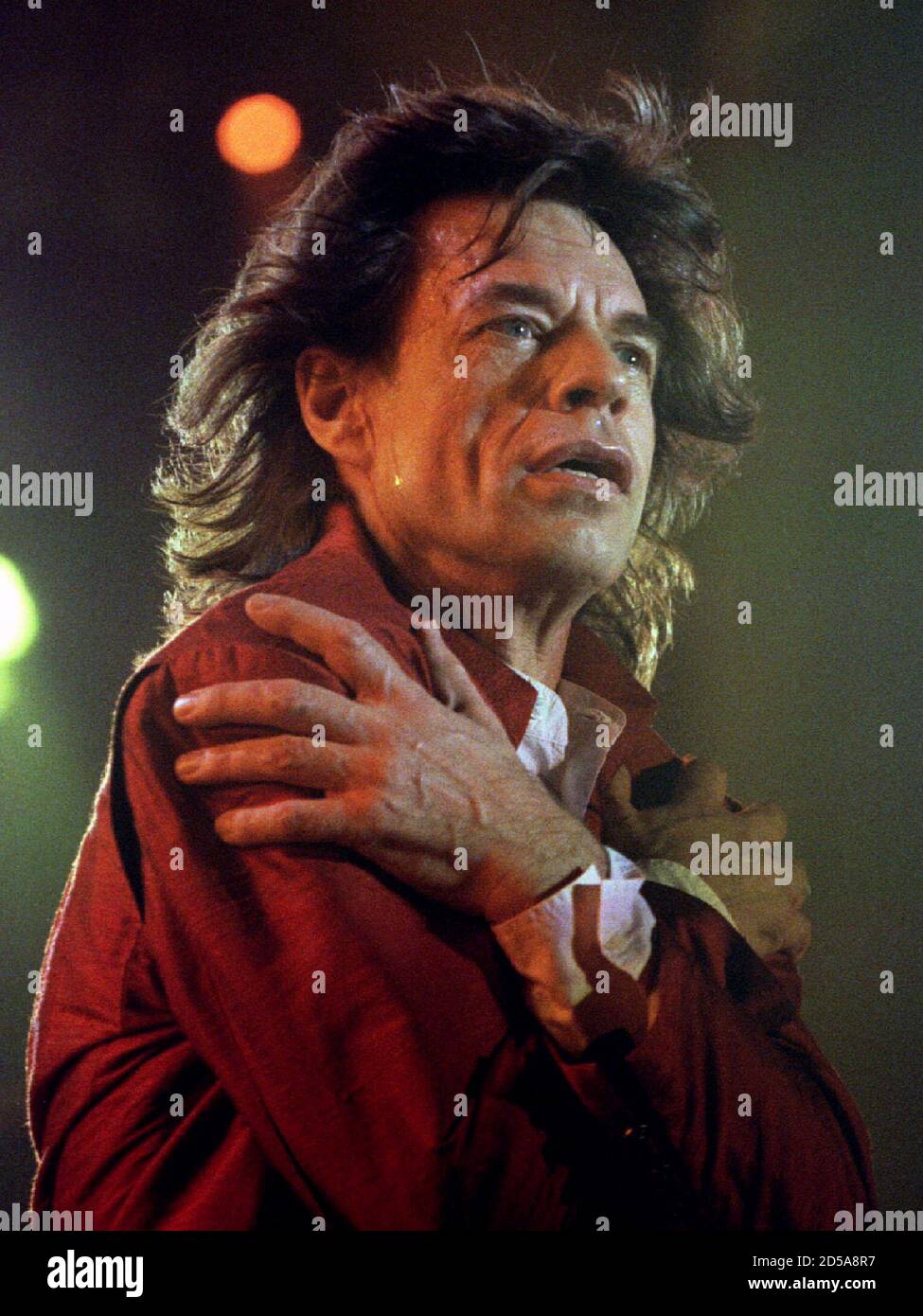 British rocker Mick Jagger performs for a packed audience at Ellis Park stadium February 25. The Rolling Stones sang to a virtually all-white audience about love and revolution Stock Photo