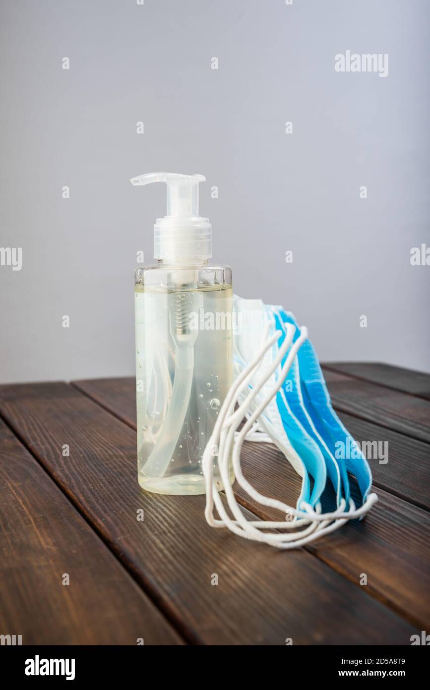 Surgical masks and hand sanitizer gel for hand hygiene spread protection Stock Photo