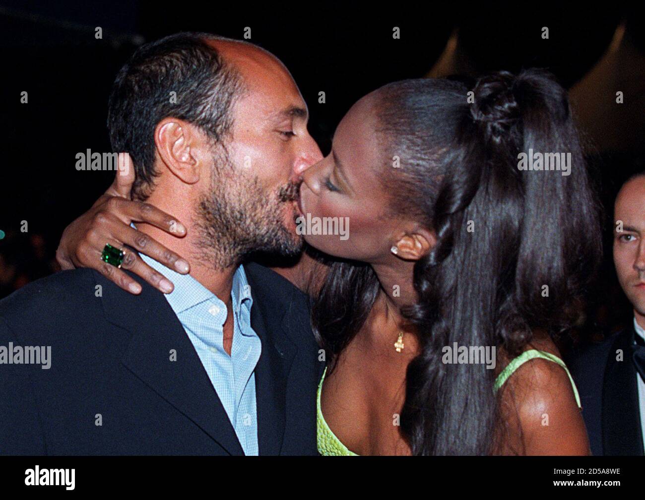 British top-model Naomi Campbell (R) kisses her unidentified companion for  photographers prior to the midnight screening of US director Spike Lee's  film "Girl 6", shown out of competition, Saturday May 11. Campbell