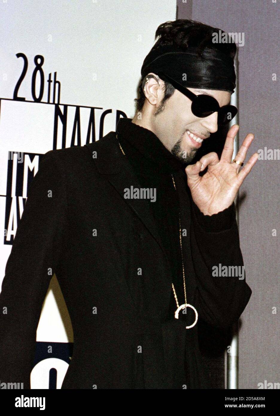 The Artist gestures after posing  for photographers February 8 at the National Association for the Advancement of Colored People (NAACP) 28th annual Image Awards in Pasadena,California. The Artist, formerly known as Prince, performed the opening musical number for the show and was presented with a Special Achievement Award. The Image Awards will be telecast February 27 on the Fox television Stock Photo