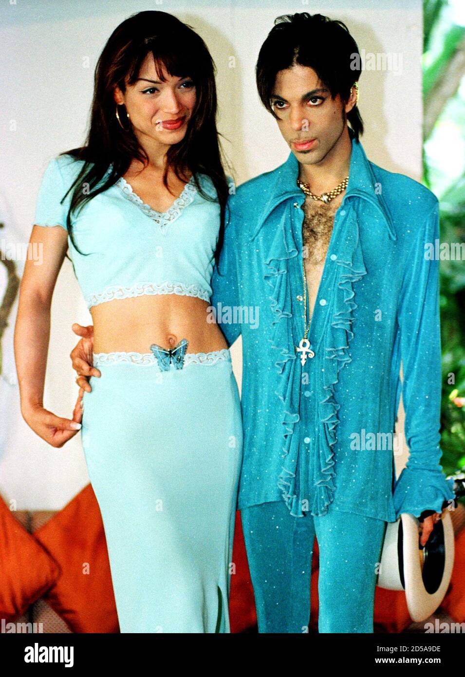 The Artist, formerly called Prince, and his wife Maite pose for the  photographers at their hotel in Marbella August 7. [The Artist will present  his latest album "Newpower Soul" at the bullfighting