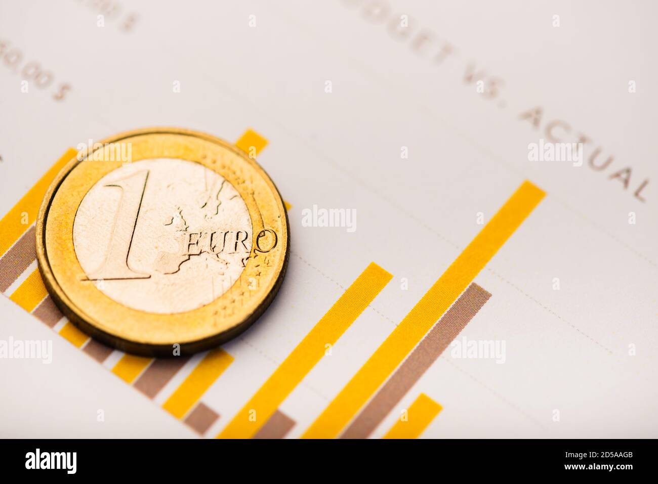 One euro coin on fluctuating graph. Rate of euro (shallow DOF) Stock Photo