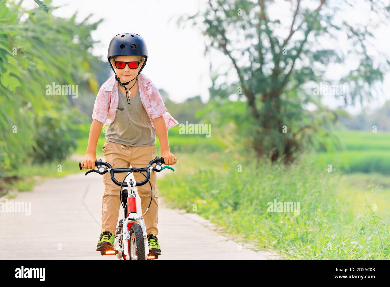 Happy Little Boy Riding a Bike Stock Image - Image of lifestyle