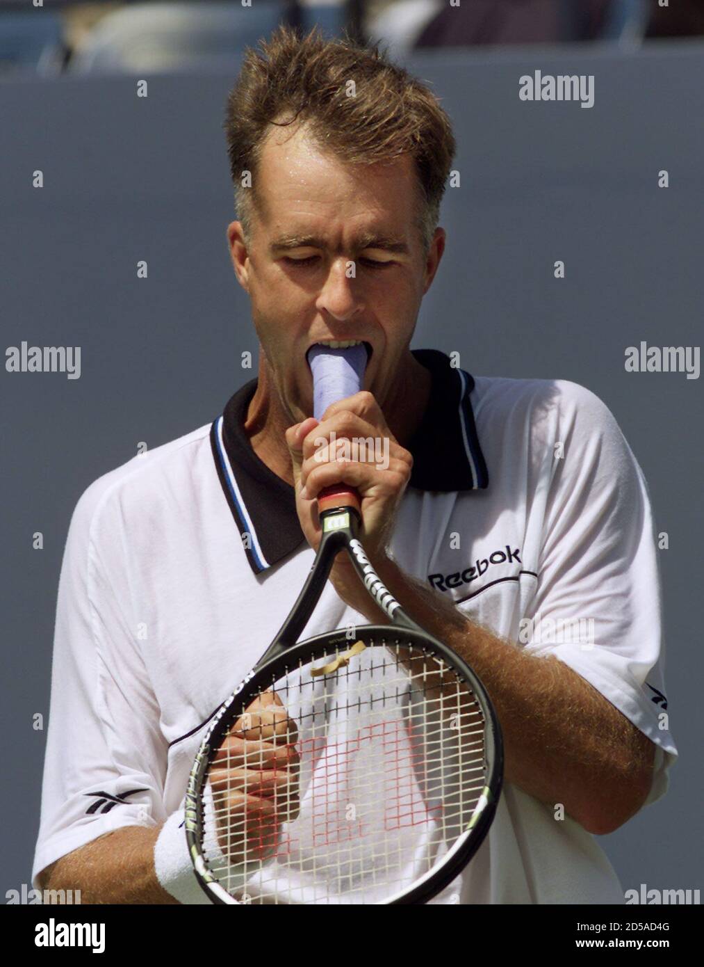 Todd Martin of the U.S. bites his racquet during his first round U.S. Open  match with Stephane Huet of France in Flushing Meadows August 31. Martin is  seeded seventh in the tournament.