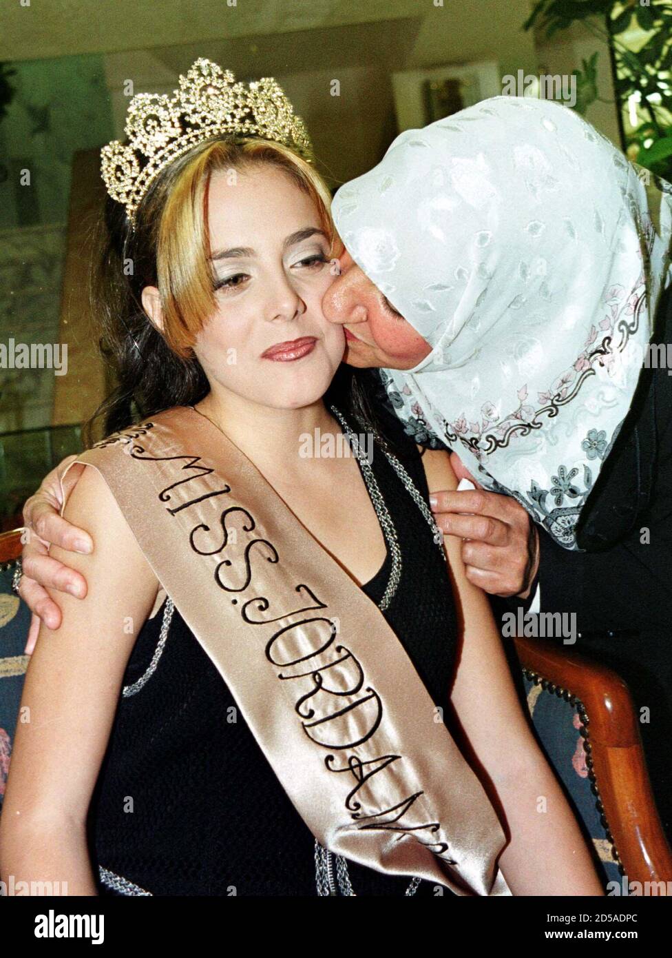 Sixteen-year-old Malak Khabon is embraced by a relative after winning the  Miss Jordan '99 contest in Amman October 29. For the first time since 1965,  a beauty contest to choose Miss Jordan
