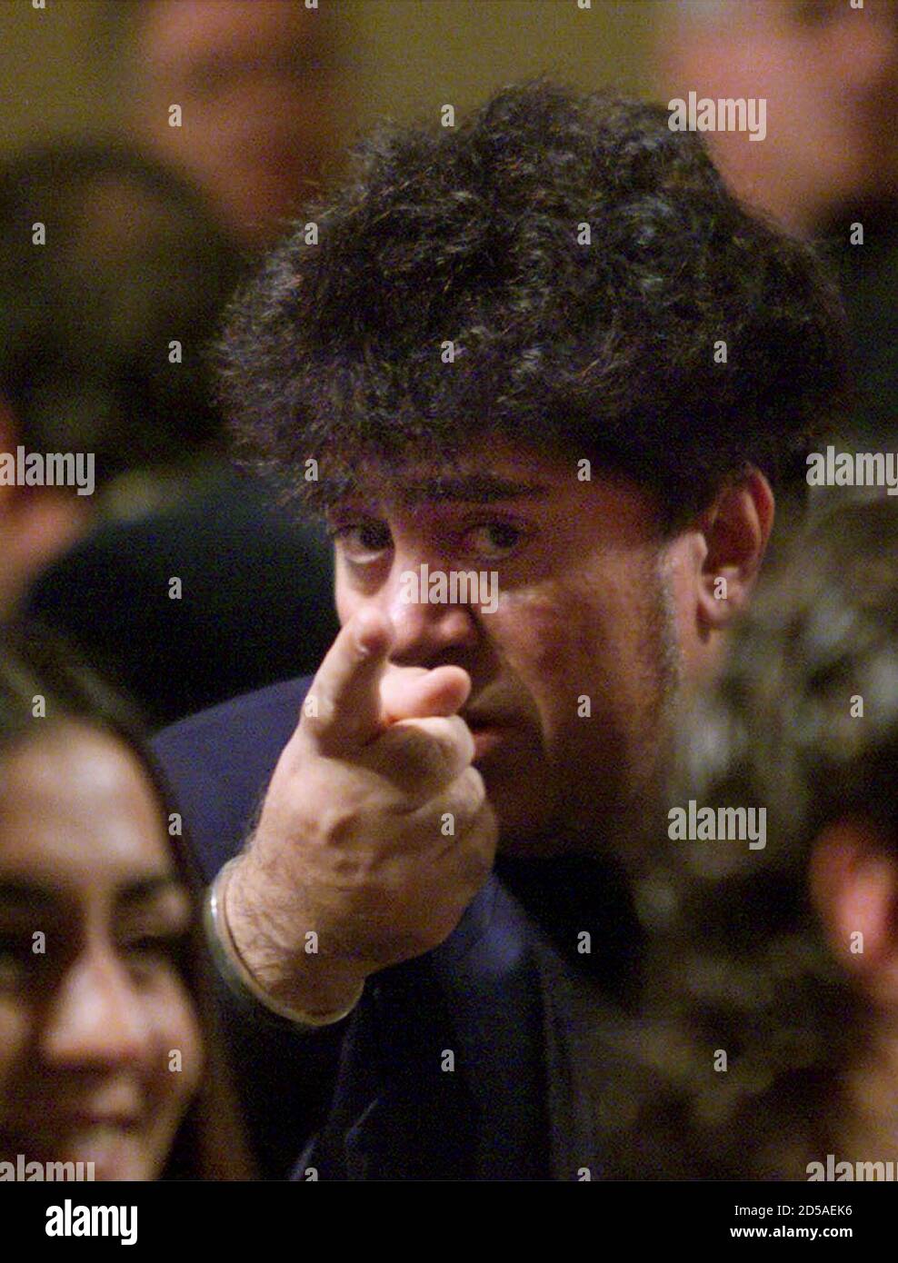 Director Pedro Almodovar points to someone in the audience during the Spanish Film Academy awards in Barcelona January 30. Almodovar won a Goya prize for best director for his film 'Todo Sobre Mi Madre' (All About My Mother). The Goyas are the Spanish equivalent to the [Oscars.] Stock Photo