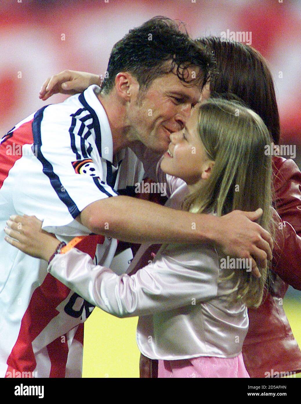 German soccer star Lothar Matthaeus (L) is hugged by his daughter Viola as  he leaves the field during a tribute match of FC Bayern Munich against the  German national soccer team May