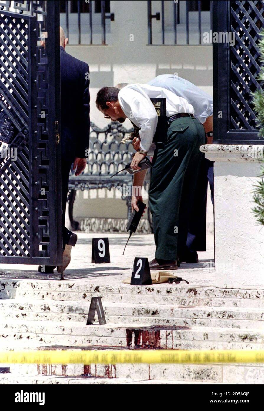 Miami Beach police look for evidence July 15 just inside the front gate of  Gianni Versace's mansion on Miami Beach. The fifty-year-old fashion  designer was shot twice in the head at close