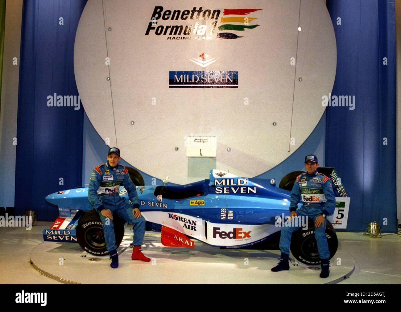 Benetton drivers Alexander Wurz from Austria (L) and Italy's Giancarlo  Fisichella display their team's new Formula One car at its launch January  15. Benetton, an Anglo-Italian team, announced a major new technical