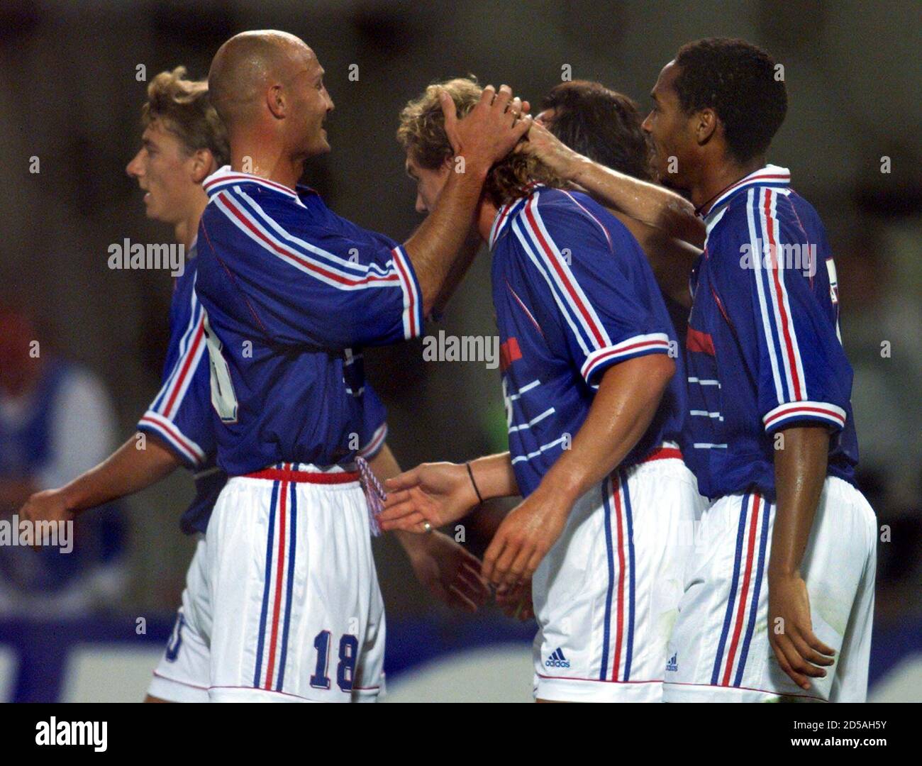 Lilian Laslandes (C) of France receives congratulations from Frank Leboeuf  (L) and Thierry Henry after he scored a goal for his team during the soccer  friendly against Austria August 19. [It is