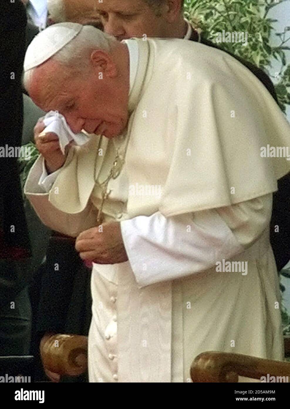Pope John Paul II wipes his face during a fair well ceremony at the Balice airport June 17. The 79-year-old Pontiff finished his 13-days visit to his home country Poland.   ??» Stock Photo