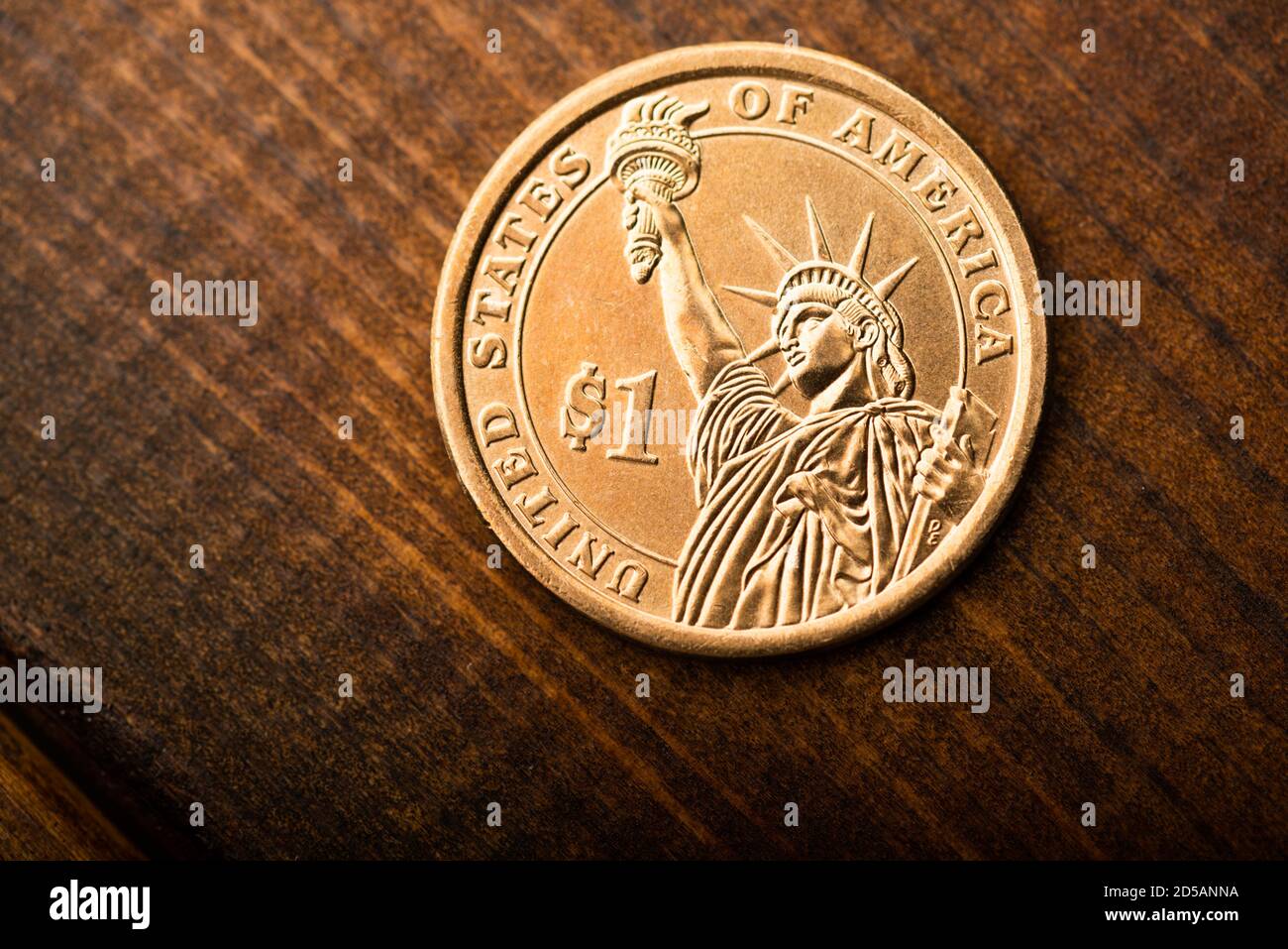 One dollar coin on desk Stock Photo