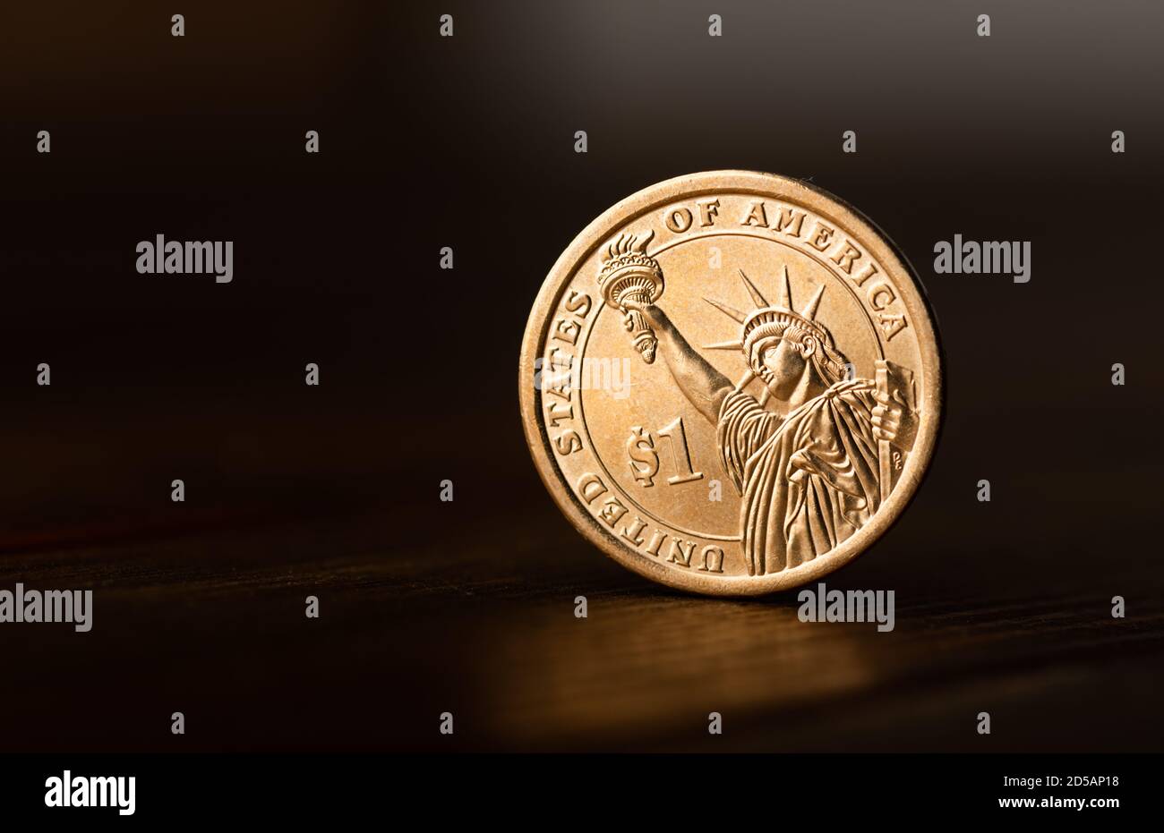 One dollar coin on desk Stock Photo