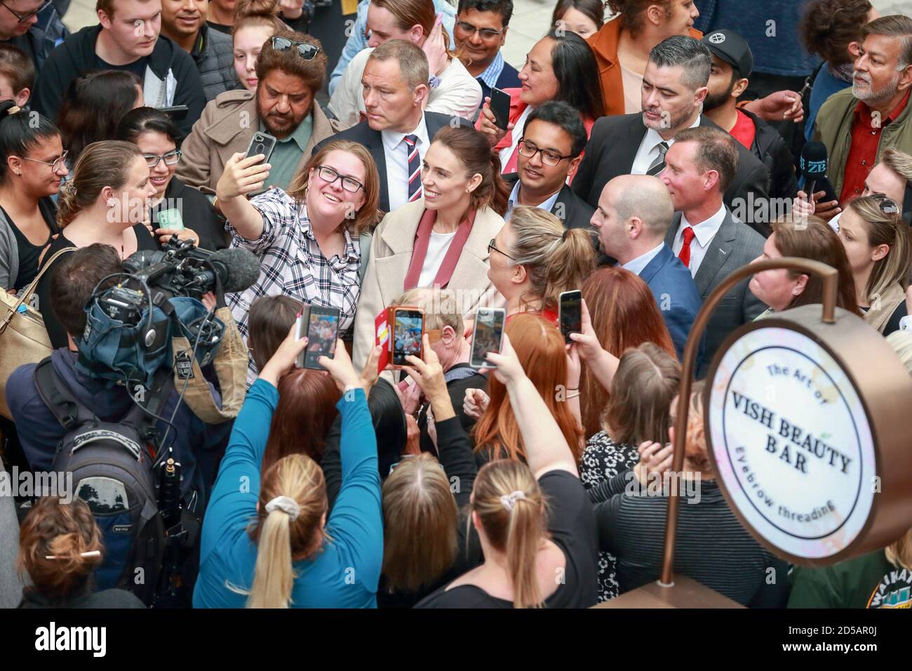 Hamilton, New Zealand. 12th Oct, 2020. New Zealand Prime Minister and Labour Party leader Jacinda Ardern makes a selfie with her supporters during an election campaign held in Hamilton, New Zealand, Oct. 12, 2020. The election day of the 2020 General Election and referendums will fall on Oct. 17. Credit: Zhu Xi/Xinhua/Alamy Live News Stock Photo