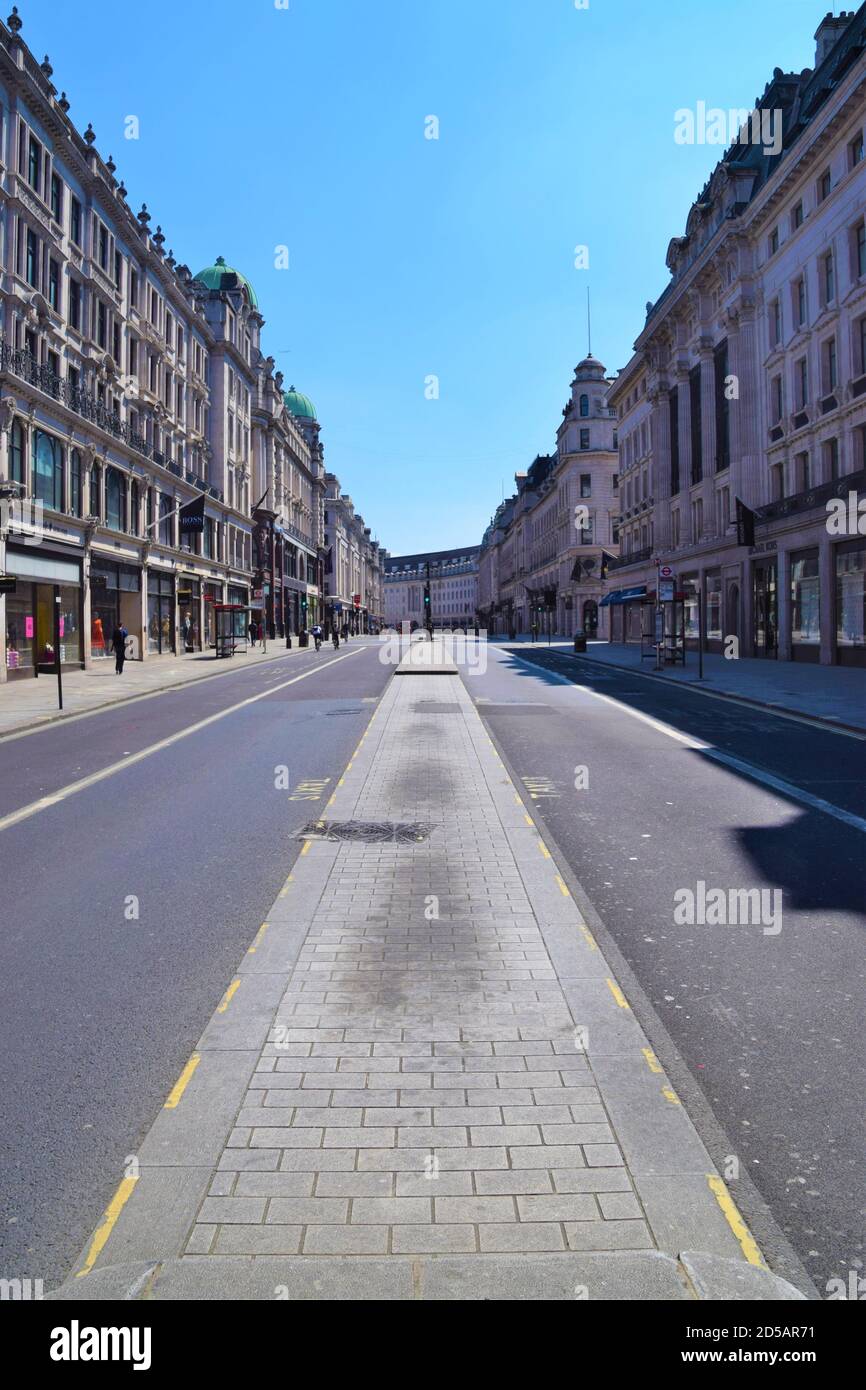 An almost entirely empty Regent Street during 2020 lockdown. The usually bustling Central London resembled a ghost town as shops and businesses were closed during the coronavirus pandemic. Stock Photo