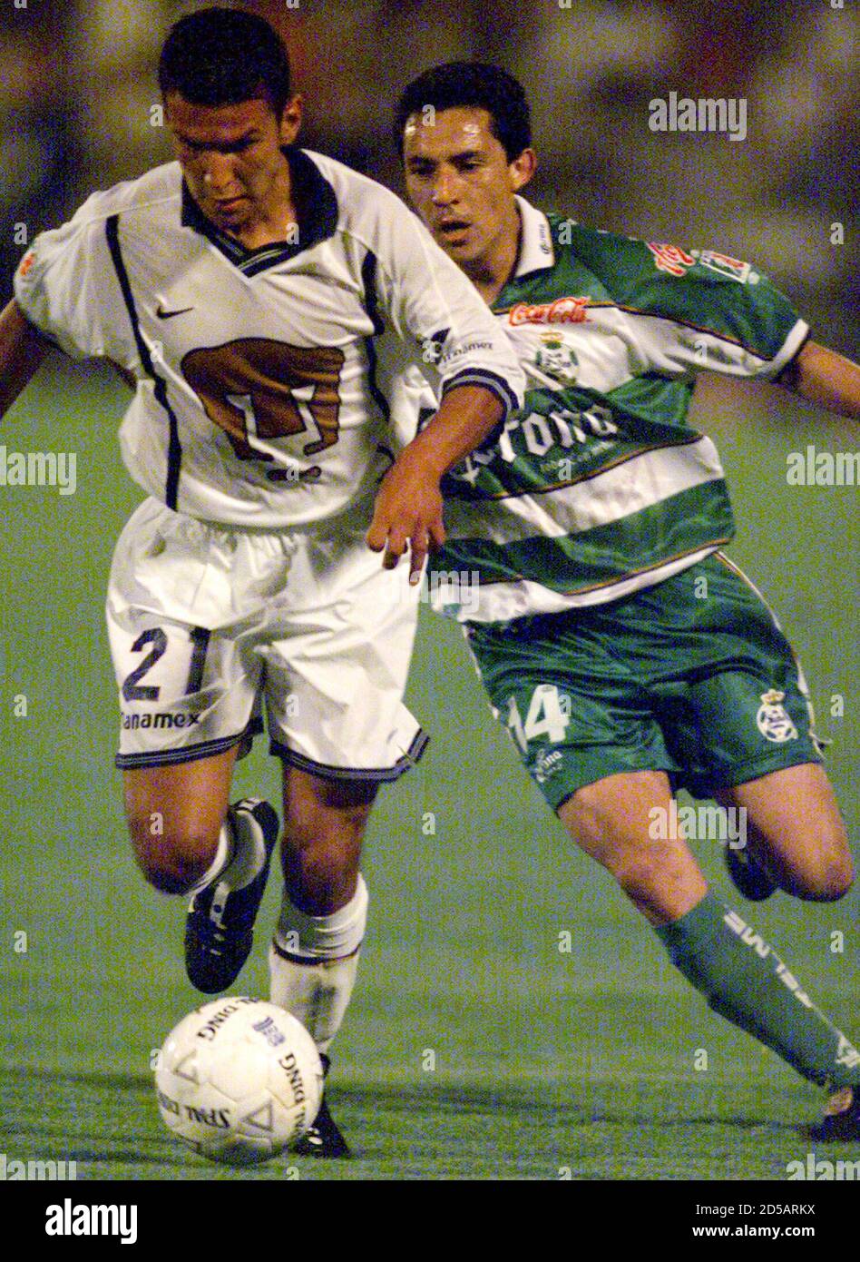 Mexican player Sergio Bernal (L) of club Pumas fights for the ball with  Miguel Garcia of club Santos Laguna during the first half of their  semifinal summer 2000 championship match in the