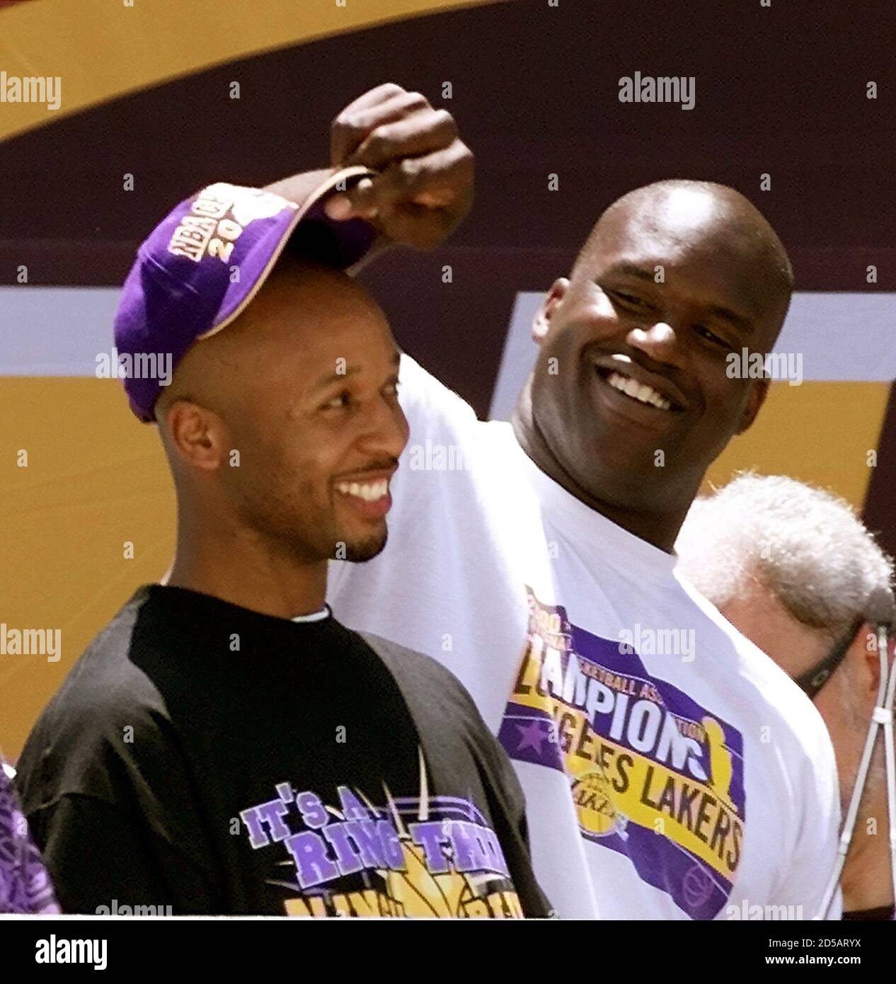 The Los Angeles Lakers Shaquille O Neal L Grabs The Hat Off Teammate Brian Shaw During A Rally After The Los Angeles Lakers Nba Championship Parade June 21 At The Staples Center In