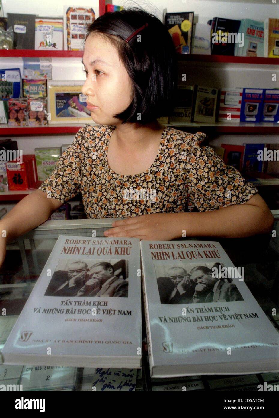 A book vendor shows copies of a translated Vietnamese version of former U.S. Defence Secretary Robert McNamara's memoirs 'In Retrospect: The Tragedy and Lessons of Vietnam,' on sale in Hanoi June 27 Stock Photo
