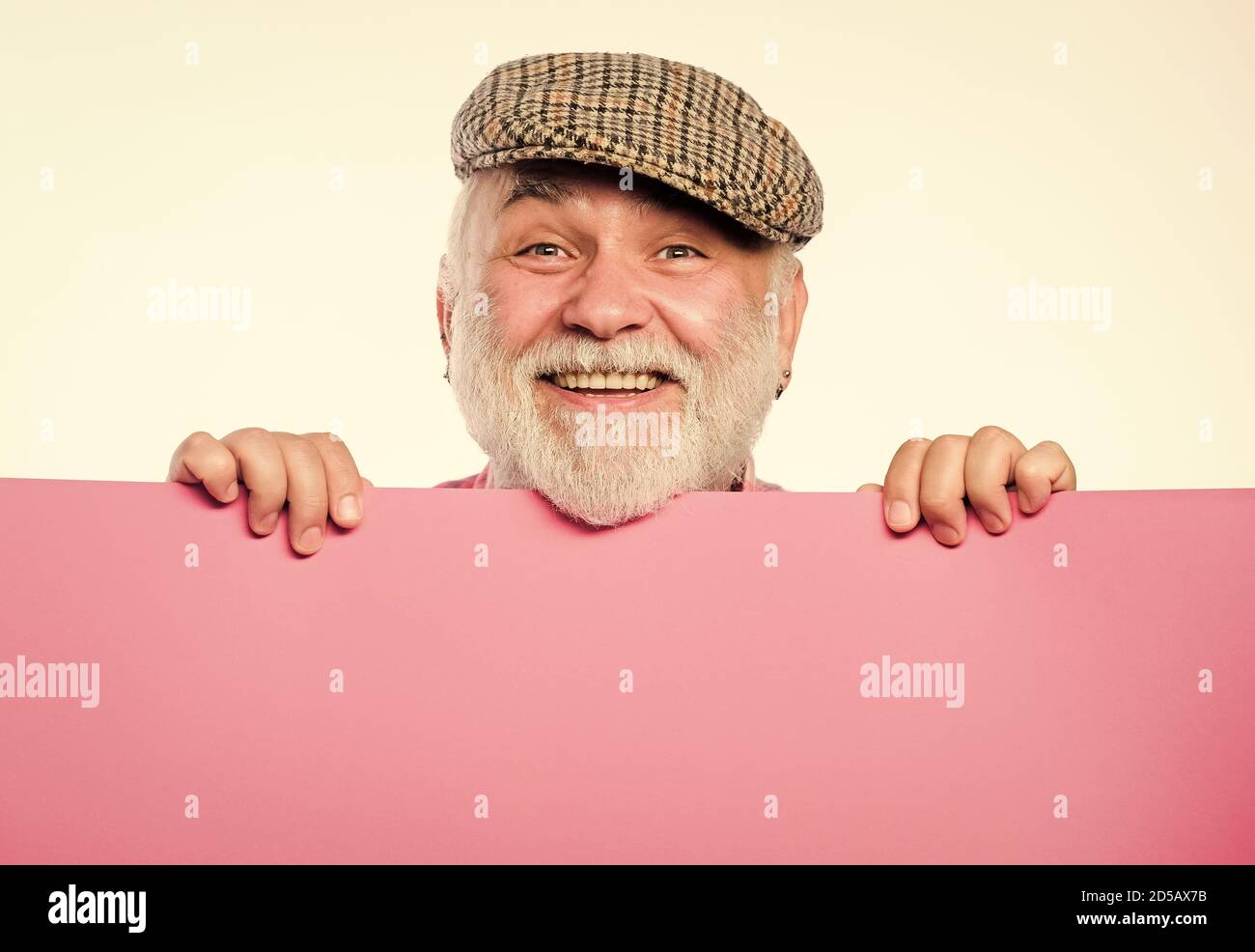 Announcement concept. Public information. Advertisement elderly people. Pensioner hold poster information copy space. Weekend entertainment. Senior bearded man peeking out of banner place information. Stock Photo